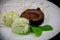 Chocolate fondant with pistachio ice cream on black background