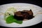 Chocolate fondant with pistachio ice cream on black background