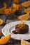 Chocolate fountain, orange cupcake. Photo of food on a dark background