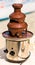 Chocolate fountain placed on a table in wedding