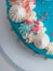 chocolate frosted blue dripped icing white cup cake, unicorn , meringue and sprinkles on top