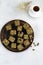 Chocolate fudge bars with nuts on a brown plate on a white background. Clean eating concept. Raw vegan dessert. Flat lay