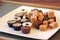 Chocolate fudge and bonbons on a white plate