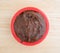 Chocolate fudge frosting in a small bowl on counter top