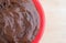 Chocolate fudge frosting in a small bowl on counter top