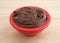 Chocolate fudge frosting in a small bowl on counter top