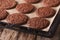 Chocolate gingerbread cookies on the baking sheet. Horizontal