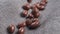 Chocolate glazed nut candies falling on a rustic jute cloth