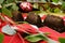 Chocolate gold nugget textured dessert on red carpet wedding dessert table with green eucalyptus leaves plant and