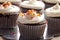 Chocolate gourmet cupcakes with sprinkles and frosting