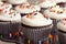 Chocolate gourmet cupcakes with sprinkles and frosting