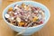 Chocolate granola with nuts, dried fruit and milk closeup