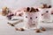 Chocolate granola with yogurt, cherries and nuts, decorated with chocolate hearts in glasses on a gray background