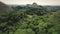 Chocolate Hills sightseeing platform aerial zoom view: mountain with tourists on greenery peak