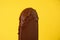 chocolate ice cream melts on yellow background