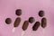 Chocolate ice lollys and french macrons on pink background.
