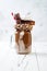 Chocolate indulgent exreme milkshake with brownie cake, marshmallow and sweets. Crazy freakshake food trend.