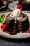 a chocolate lava cake with ice cream and raspberries