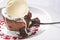 Chocolate lava cake Molten with melting ice cream, chocolate with spoon on plate and white background