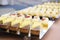 Chocolate, lemon, vanilla and strawberry cheesecakes stand in a row on mirrored trays