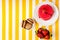 Chocolate macaroni cake, raspberry cake, fresh strawberries on a white and yellow striped background.