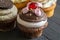 Chocolate and marshmallow decorated cup cake with cherry on top