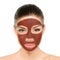 Chocolate mask woman putting diy homemade cocoa past or natural clay mud on face for facial treatment. Asian beauty