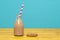 Chocolate milkshake with straw in a bottle with a cookie