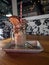 Chocolate milkshake with a waffle on it on a tray in a cafe with a blurry background