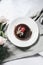 Chocolate Mousse Cake and topped with Raspberries and pink rose on a light background.