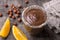 Chocolate mousse with cream, hazelnuts and orange in glasses on wooden table