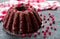 Chocolate muffin with cherry, cranberry and lecker on a white wooden background. Close-up.