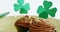 Chocolate muffin with chocolate cream topping and shamrock stick for st patricks