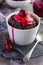 Chocolate muffin with cream and cherry sauce in a ramekin