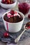 Chocolate muffin with cream and cherry sauce in a ramekin