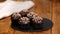 Chocolate muffin with crushed nuts on wooden background.