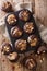 Chocolate muffins with peanut butter and nuts in a baking dish. Vertical top view