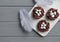 Chocolate nests with sweet eggs on gray wooden background