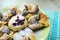 Chocolate nugget puff pastry flower with the vanilla sauce and sour cherry covered with powdered sugar