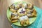 Chocolate nugget puff pastry flower with the vanilla sauce and sour cherry covered with powdered sugar, green and brown wooden bac