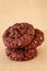 Chocolate oats cookies with chocolate nuts spread. Beige background. Selective focus