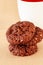 Chocolate oats cookies with chocolate nuts spread. Beige background. Selective focus