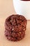 Chocolate oats cookies with chocolate nuts spread. Beige background. Selective focus