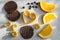Chocolate and orange topped biscuit. Orange peel in heart shape on grey background