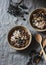 Chocolate overnight oat - healthy vegetarian breakfast on a grey background, top view. Flat lay