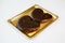 Chocolate pastries in a gold tray on white background