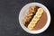 Chocolate, peanut-butter, banana, smoothie bowl on slate