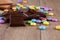 Chocolate pieces with color smarties on wooden board