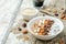 Chocolate quinoa breakfast with coconut shaving, pecan, hazelnut and chocolate slices