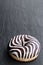 Chocolate ripple stripe doughnut on black stone background